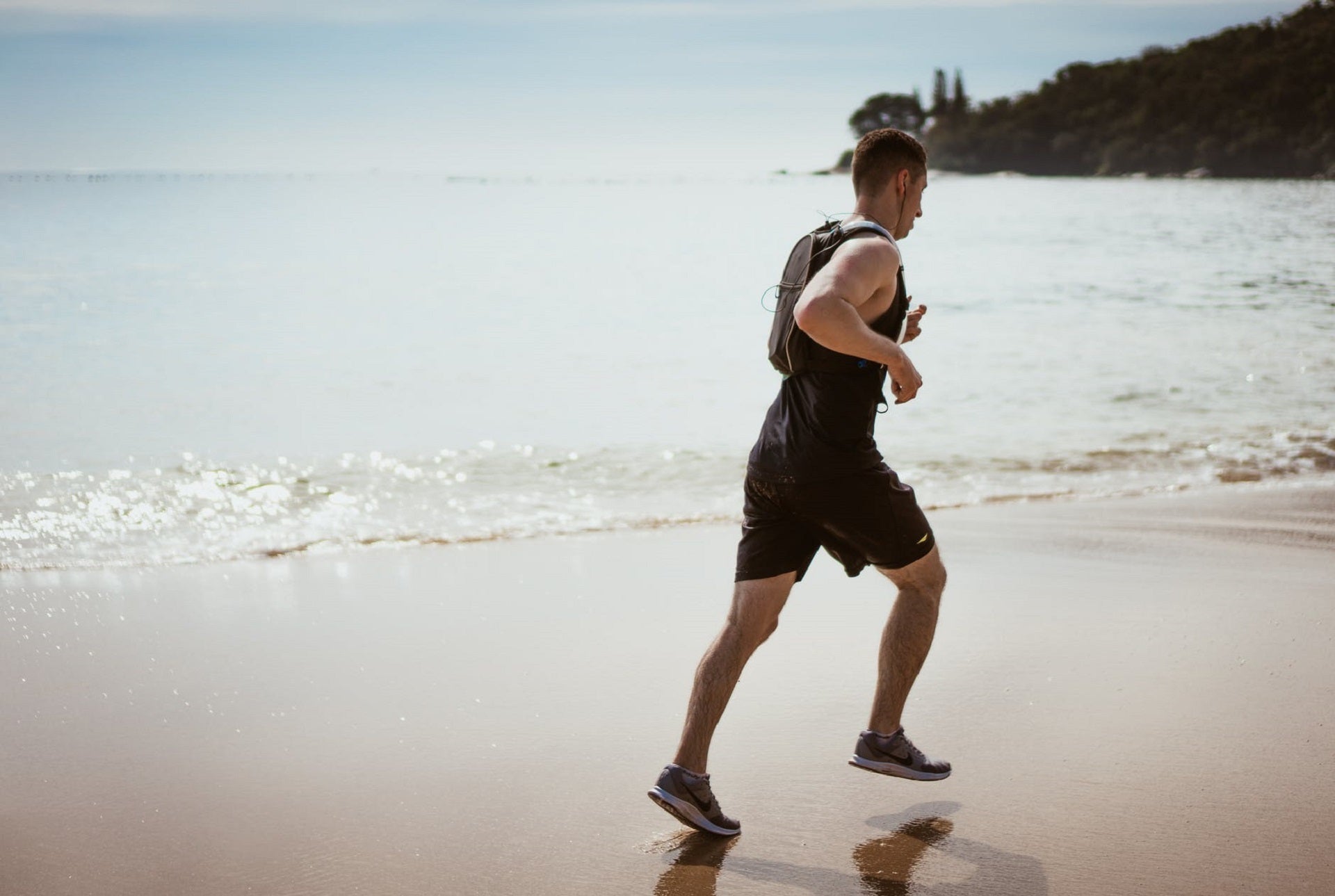 man jogging on beach