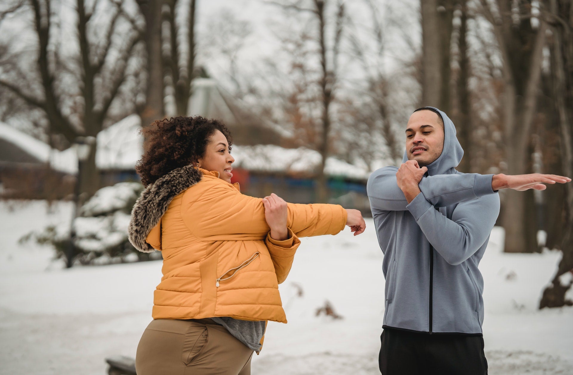 man and woman warming up for exercise to boost energy