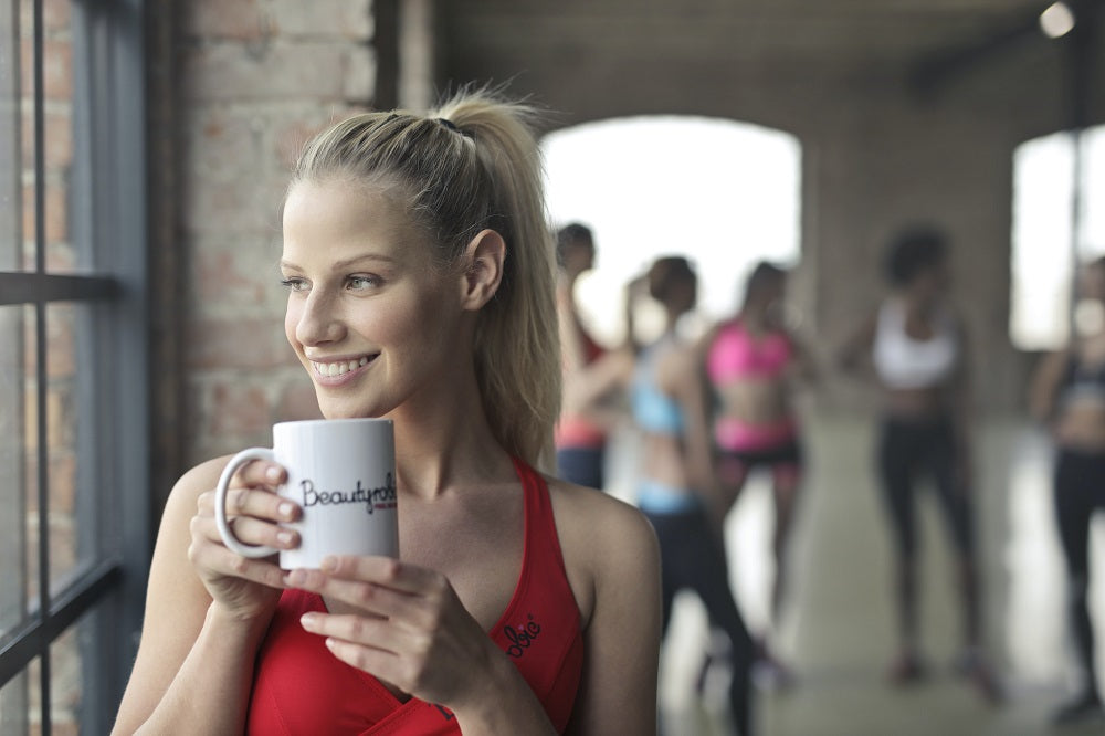 woman taking supplements after work out yo boost mood and health naturally