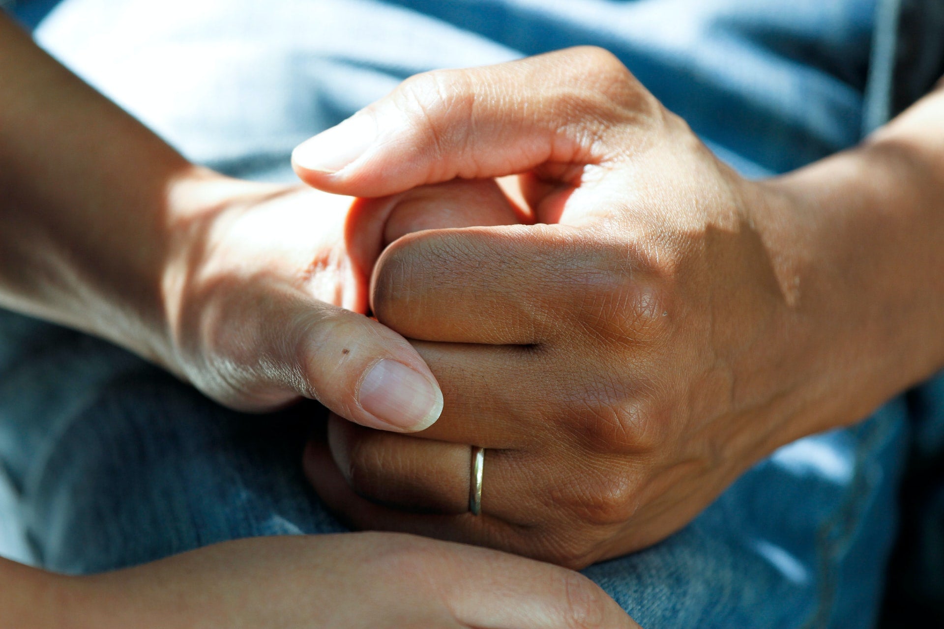 hand comforting hand of cancer patient