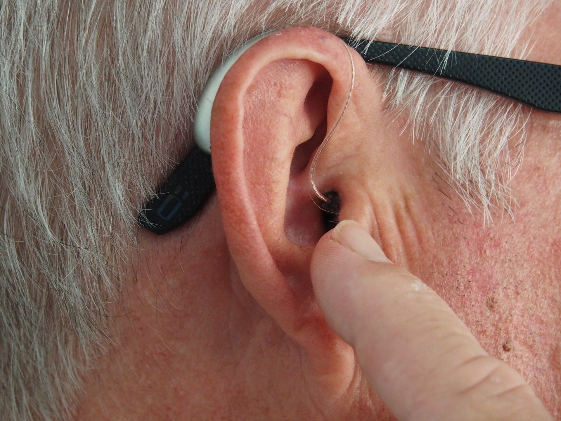 man getting fitted with hearing aid