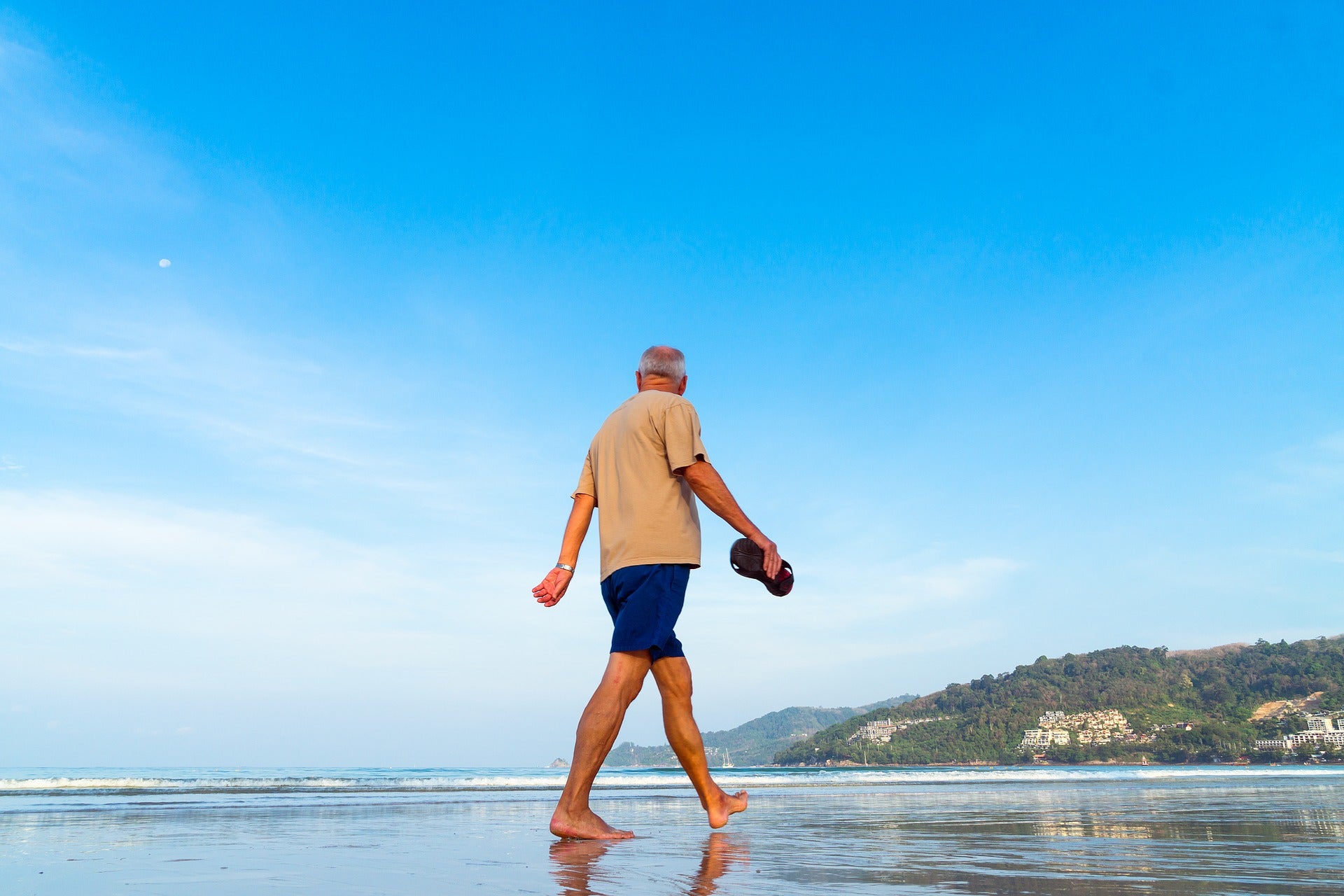 senior walking on beach