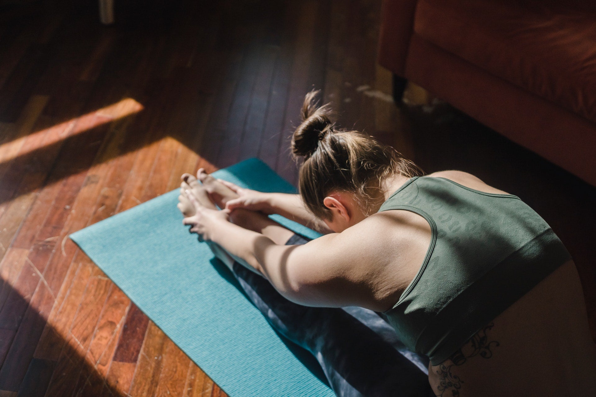 woman stretching on floor mat