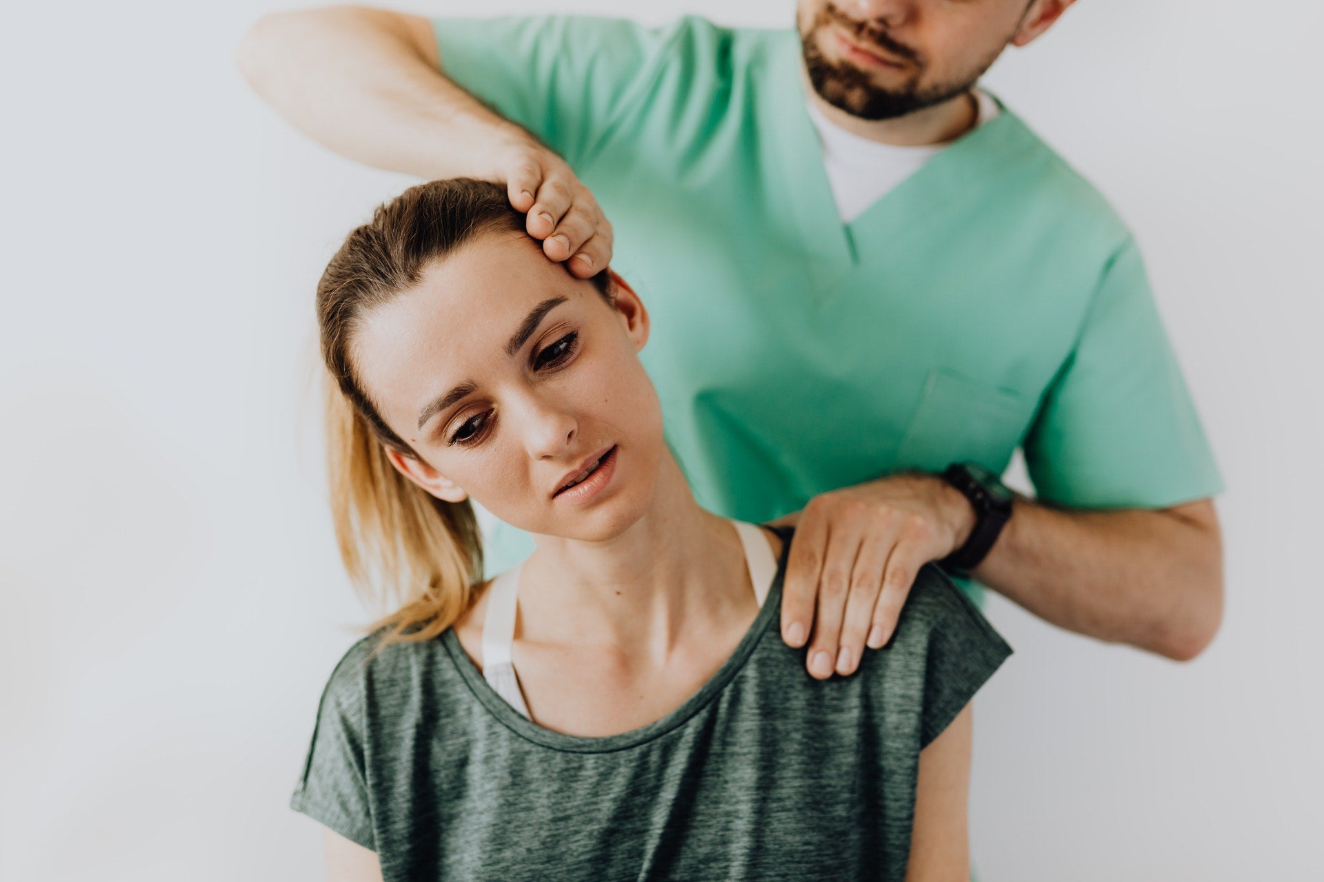 woman having neck pain checked