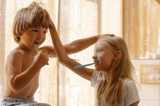 boy and girl brushing teeth