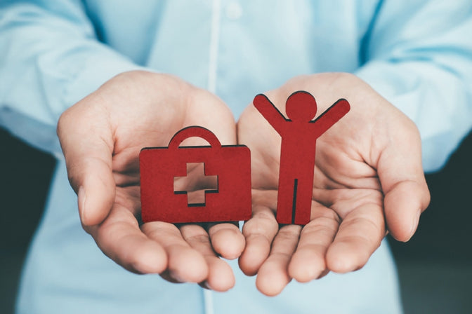 hands holding medical insurance figures 