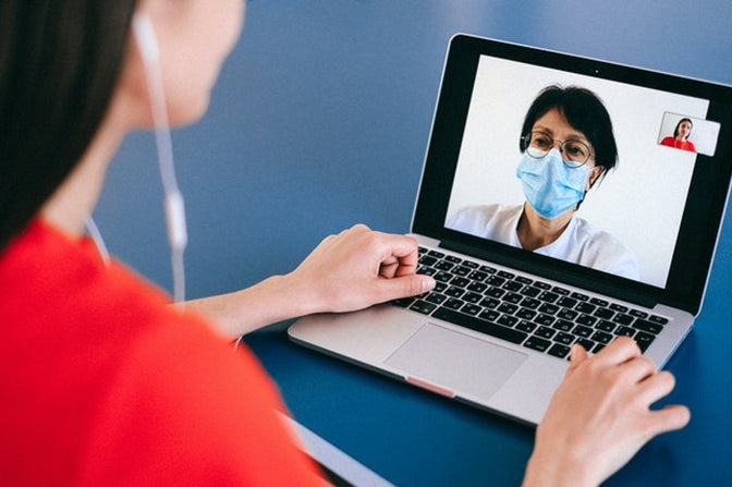 woman using telehealth services with doctor