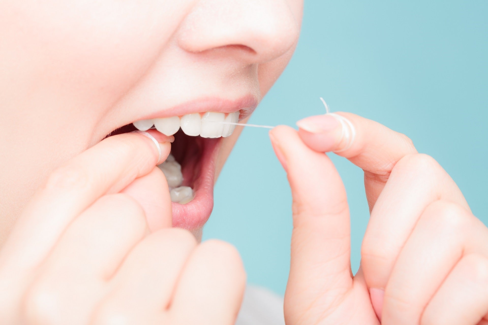 woman flossing teeth