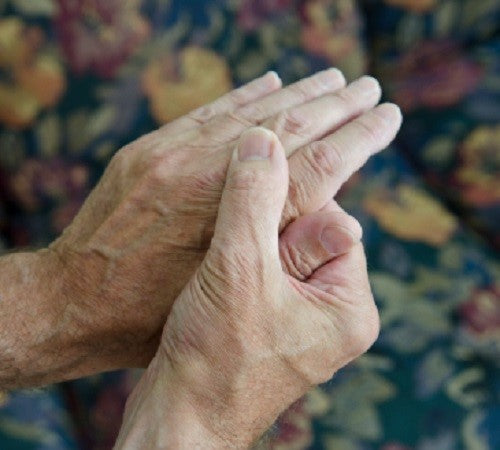 old woman hands having arthritis pain during winter
