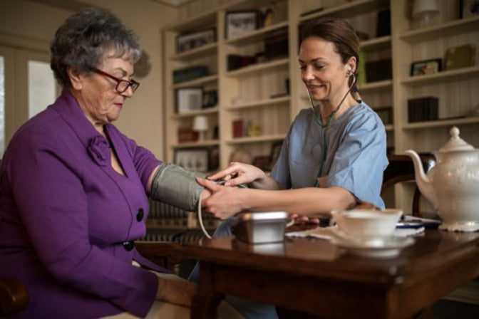 doctor and patient checking blood pressure