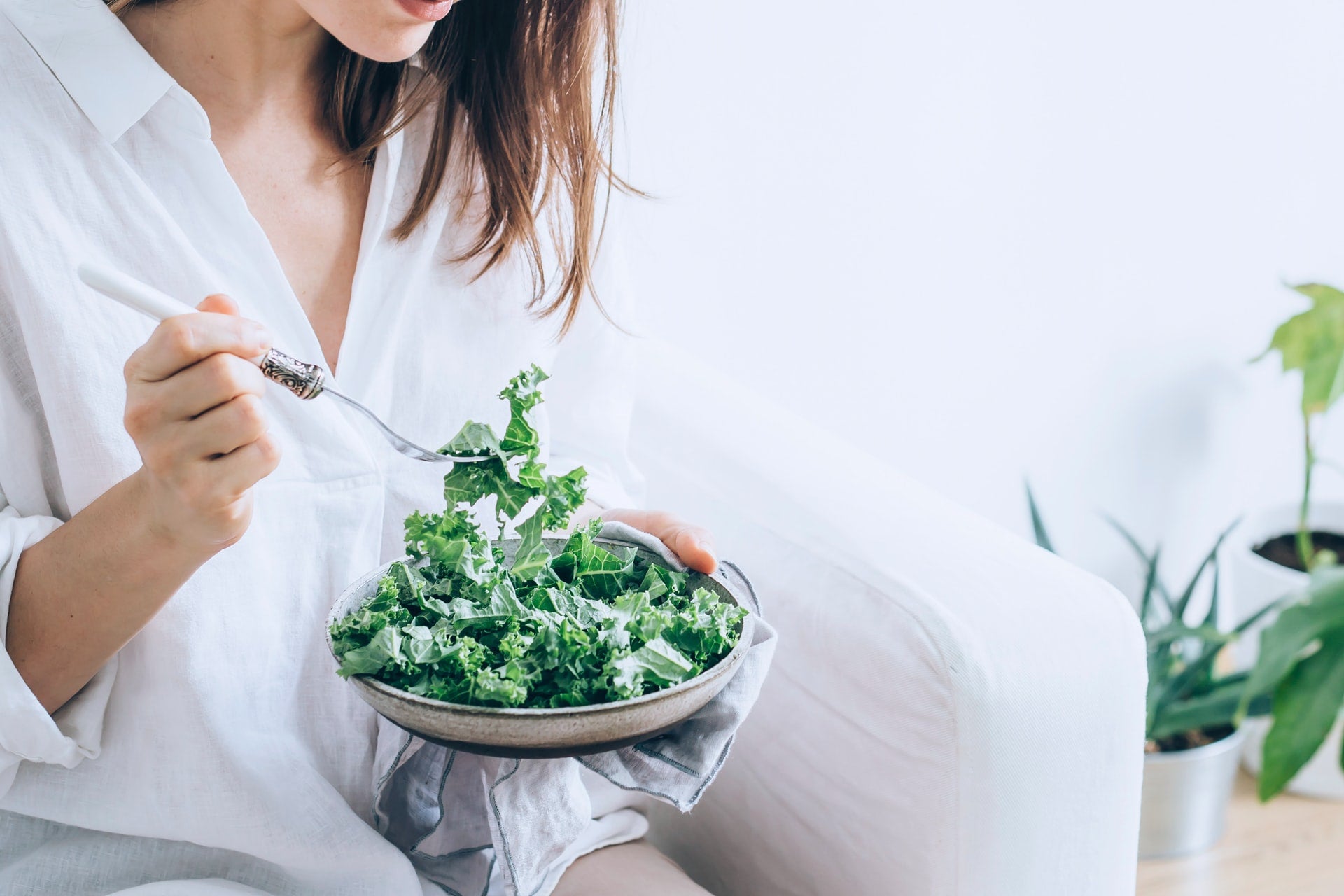 woman eating salad for bone strength