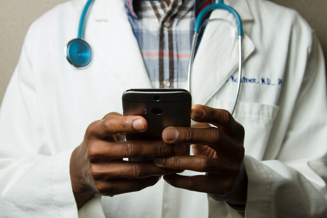 doctor using cell phone for healthcare communication