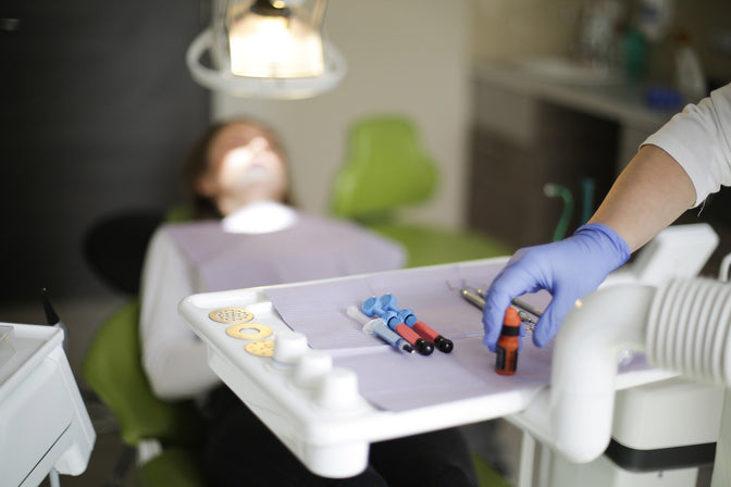 dentist administering canker sore treatment