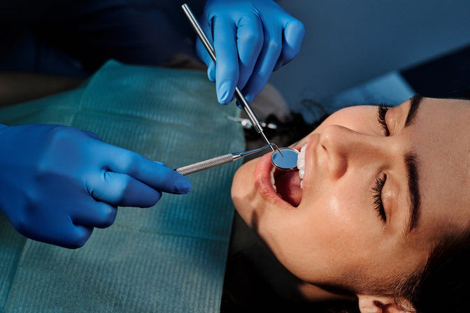 dentist checking patient for cavities