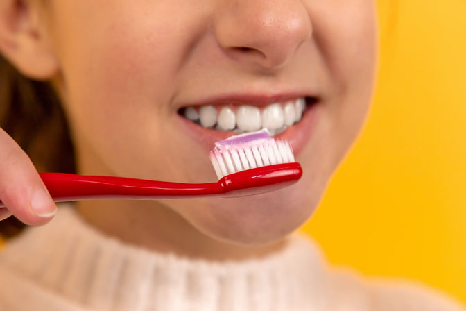 girl brushing teeth for cavity prevention