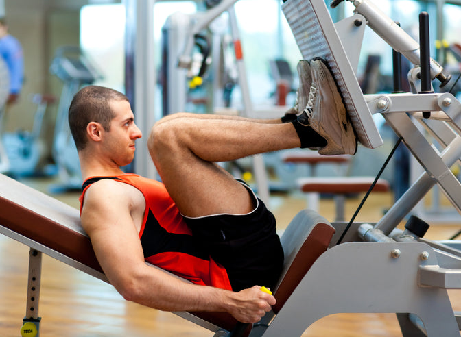 man using leg press machine