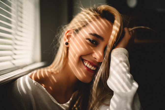 smiling girl with improved teeth after having cosmetic treatments