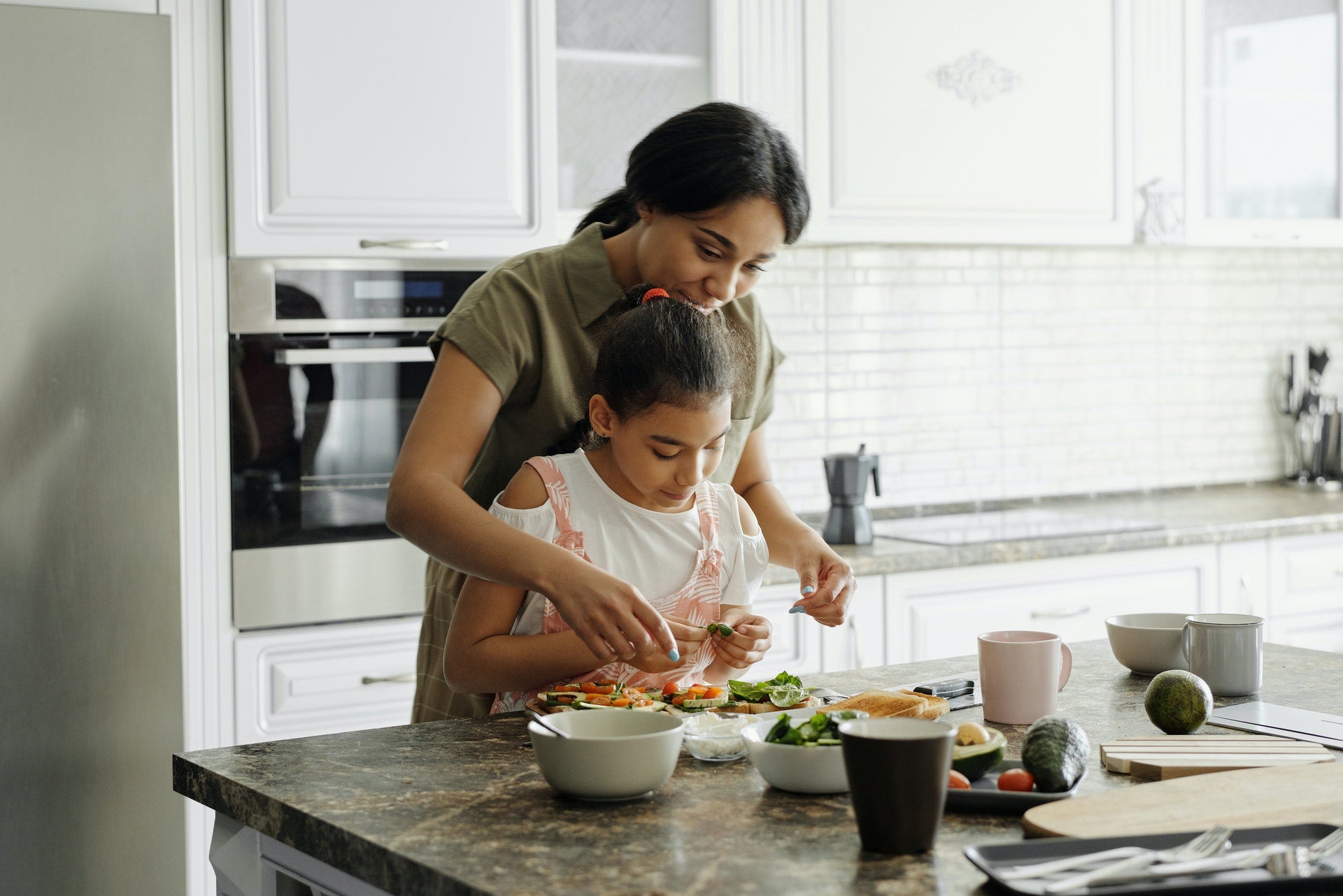 woman and child cooking for health and wellbeing
