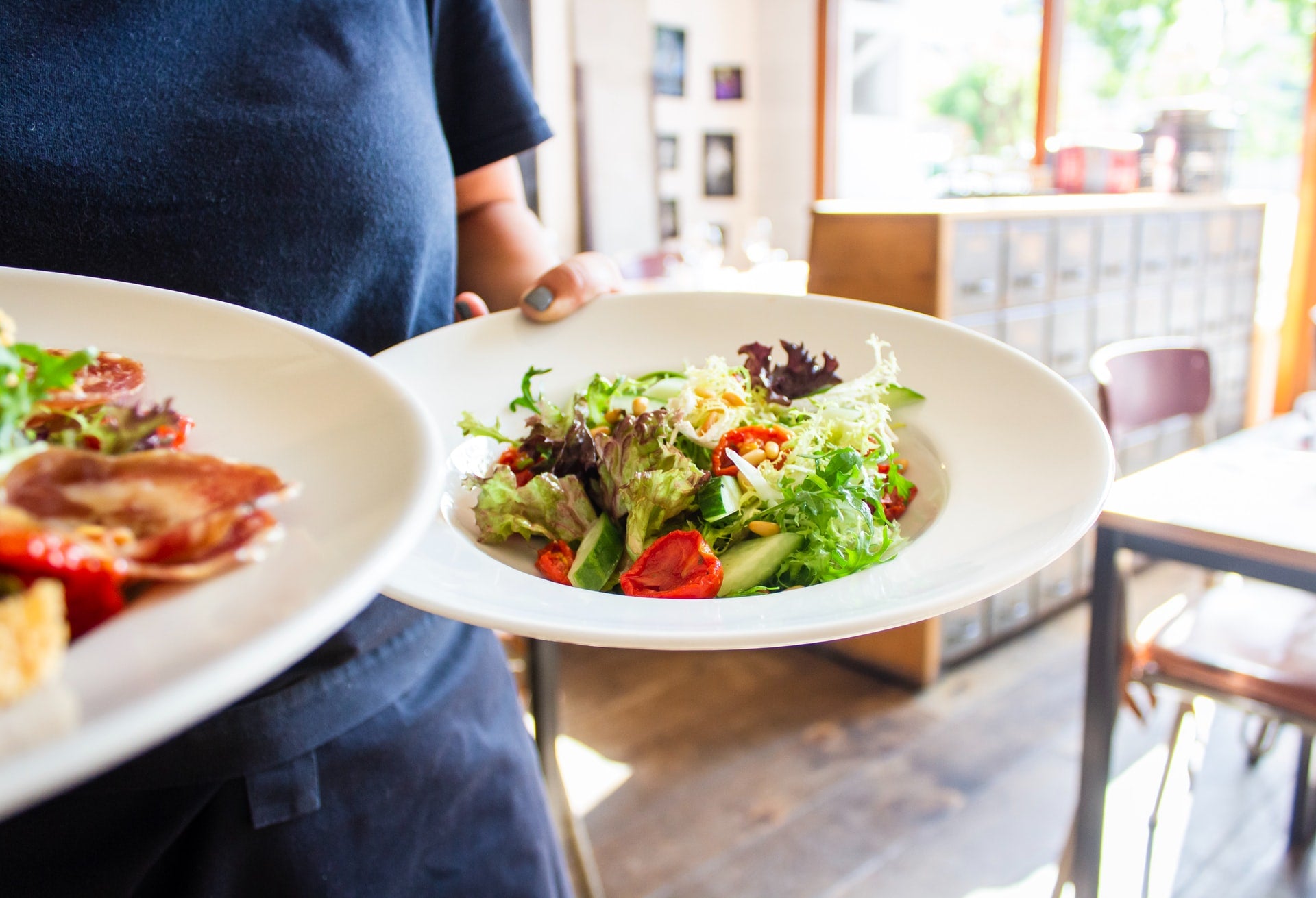 woman carrying healthy salads
