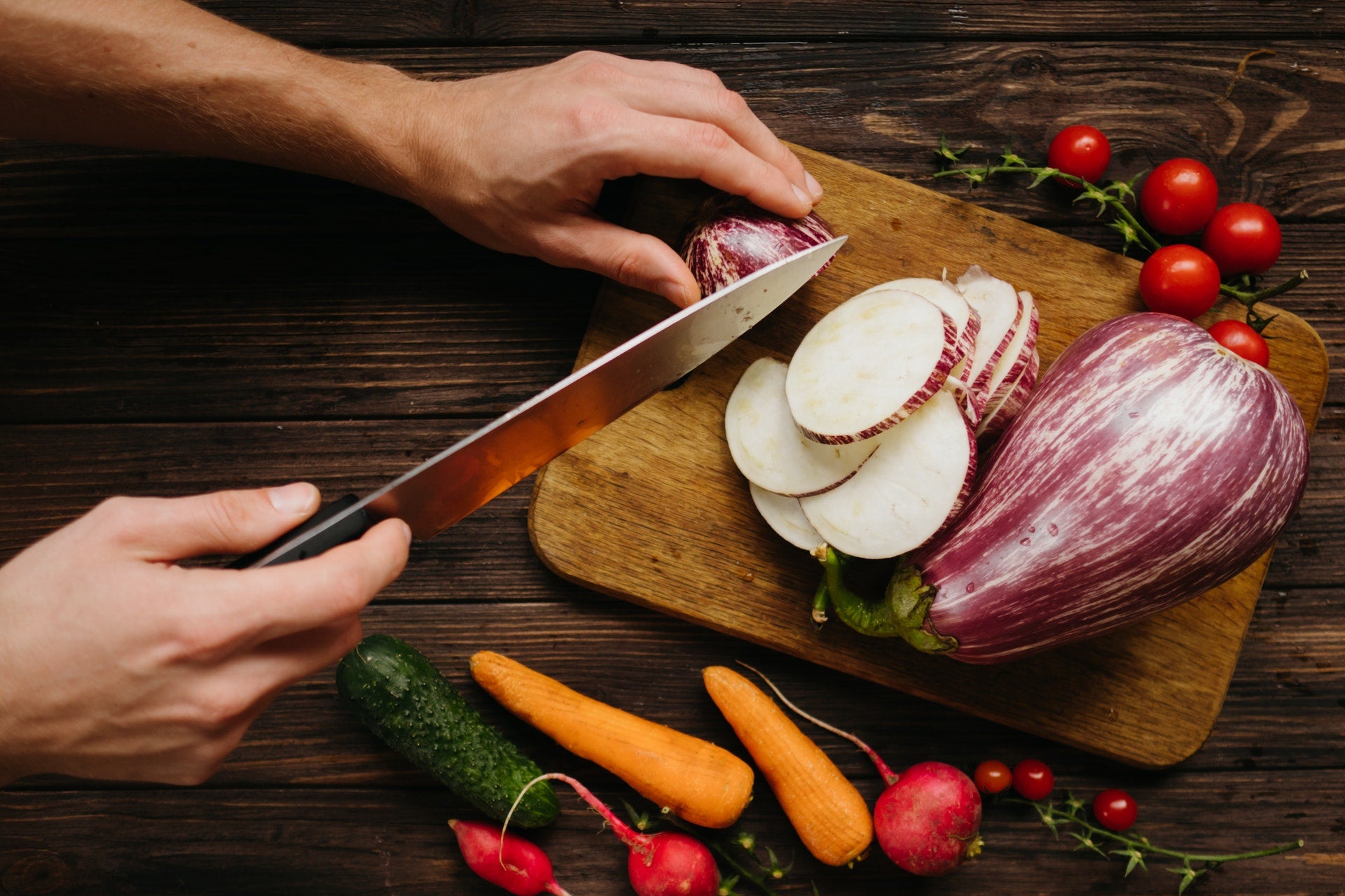 person cutting vegetables for plant-based diet