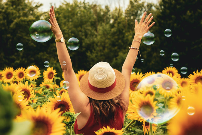 woman walking in flowers to elevate mood