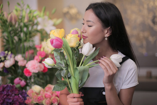 woman smelling flowers