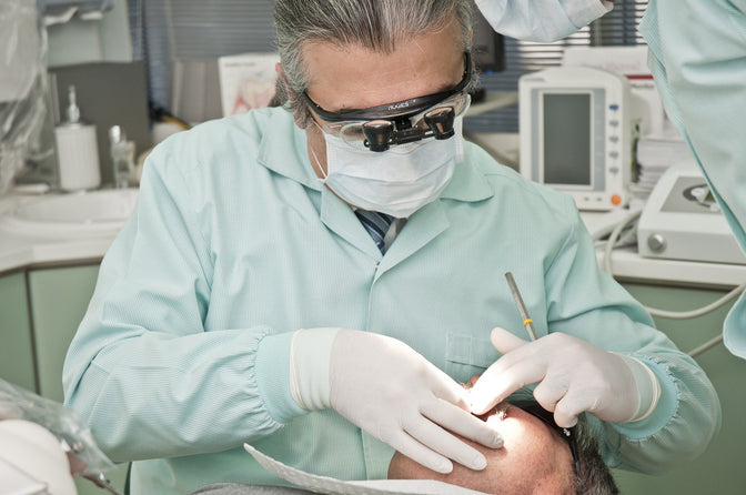 dentist checking patient gingivitis causes