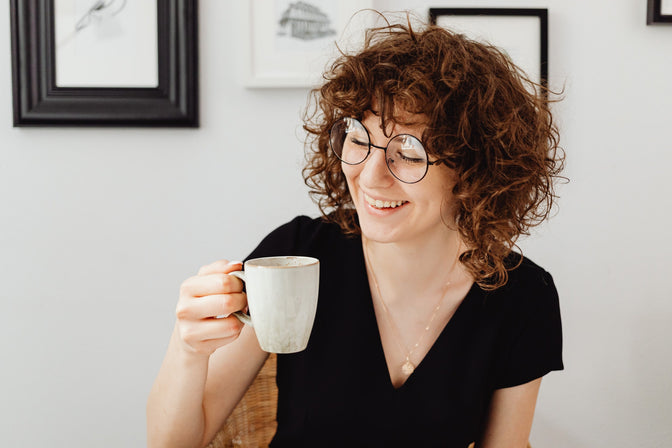 woman drinking cup of green tea