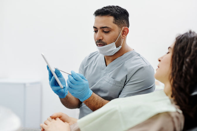 dentist explaining bleeding gums to patient