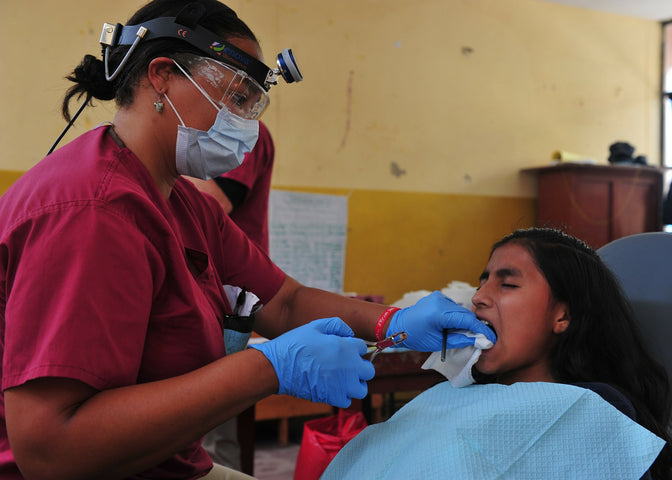 dentist looking at patient's gums