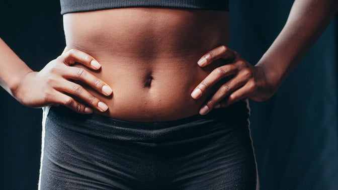 woman with hands on hips showing stomach