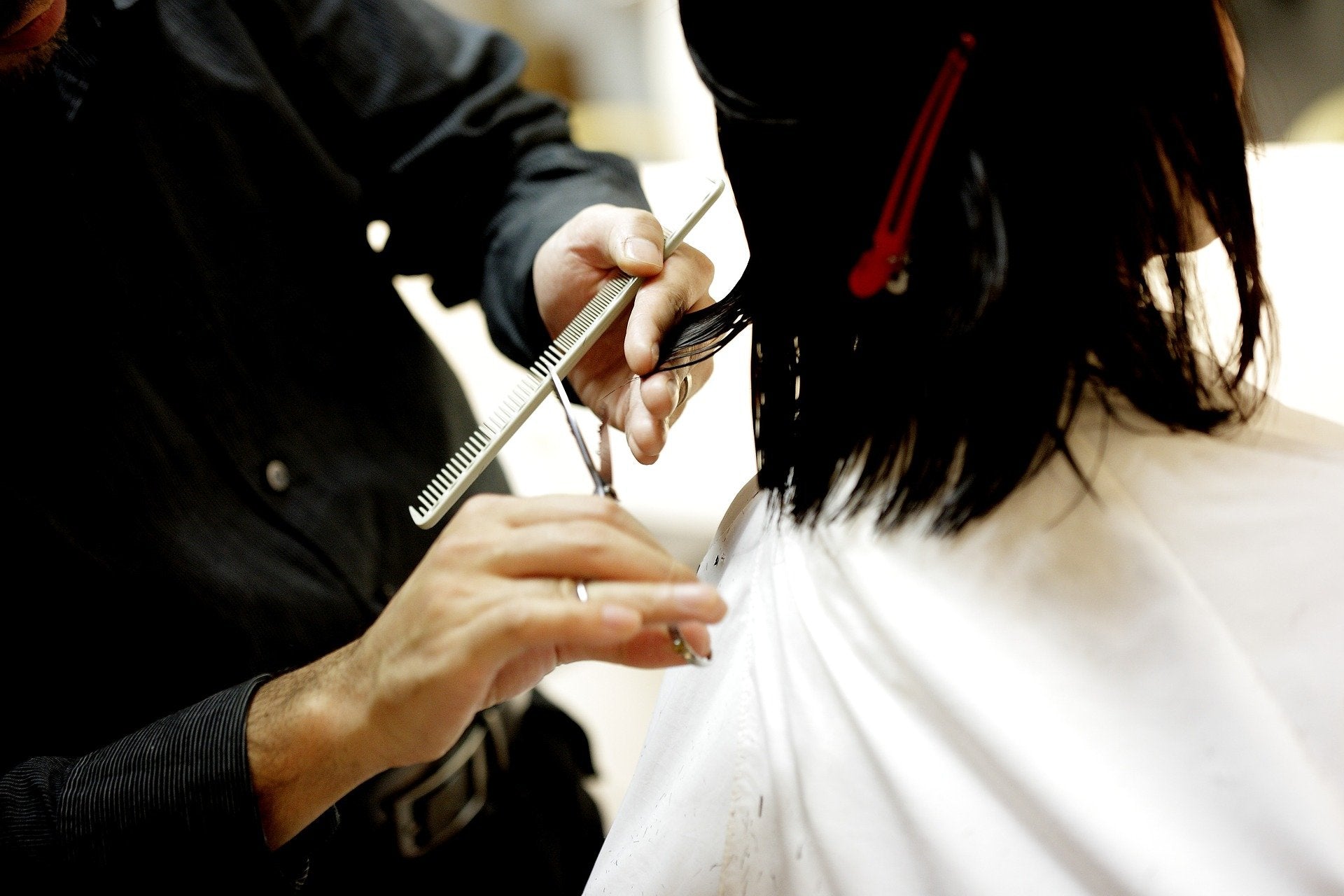 woman getting haircut to combat hair loss