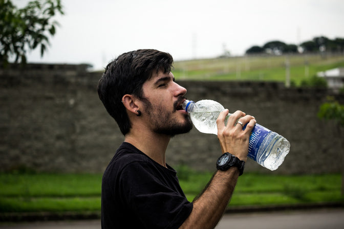 man drinking bottled water