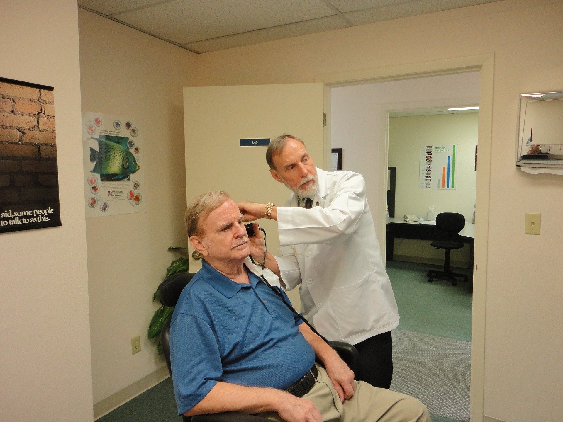 man getting examined for hearing aids