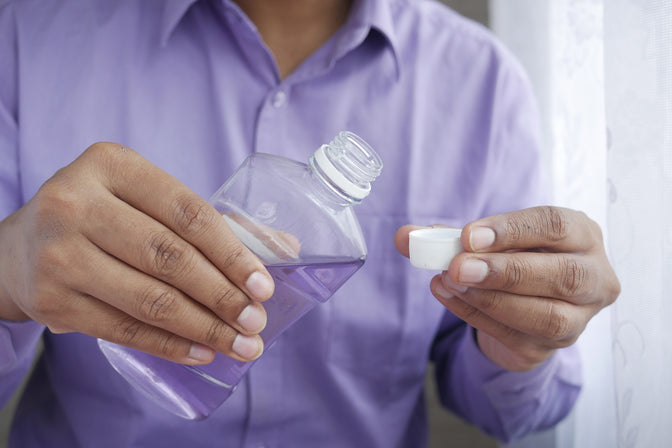 person pouring hydrogen peroxide