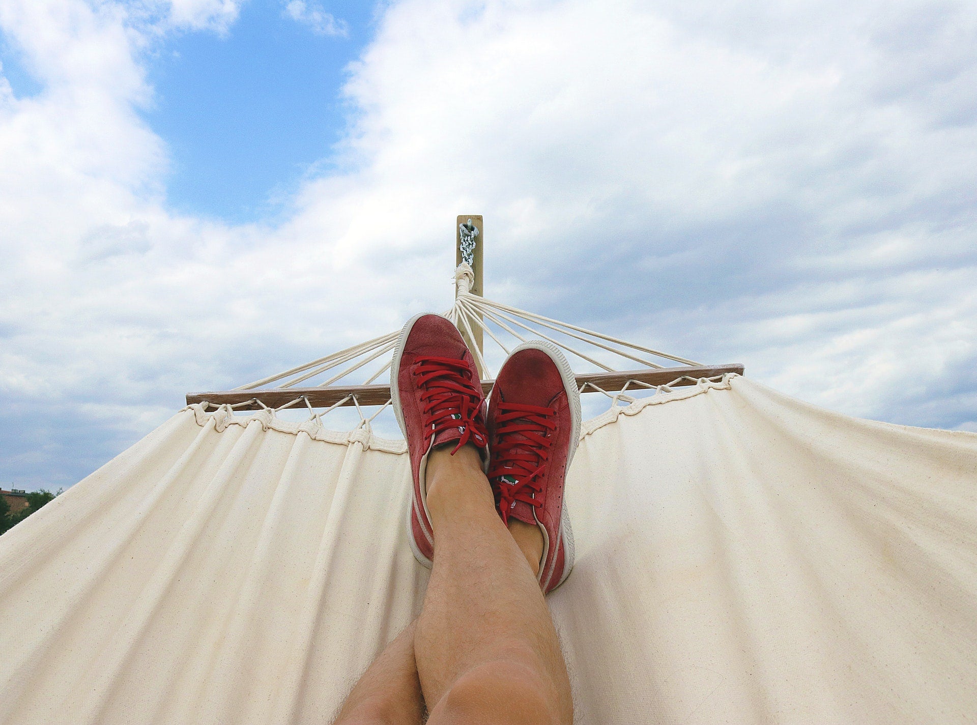 person relaxing in hammock to improve health