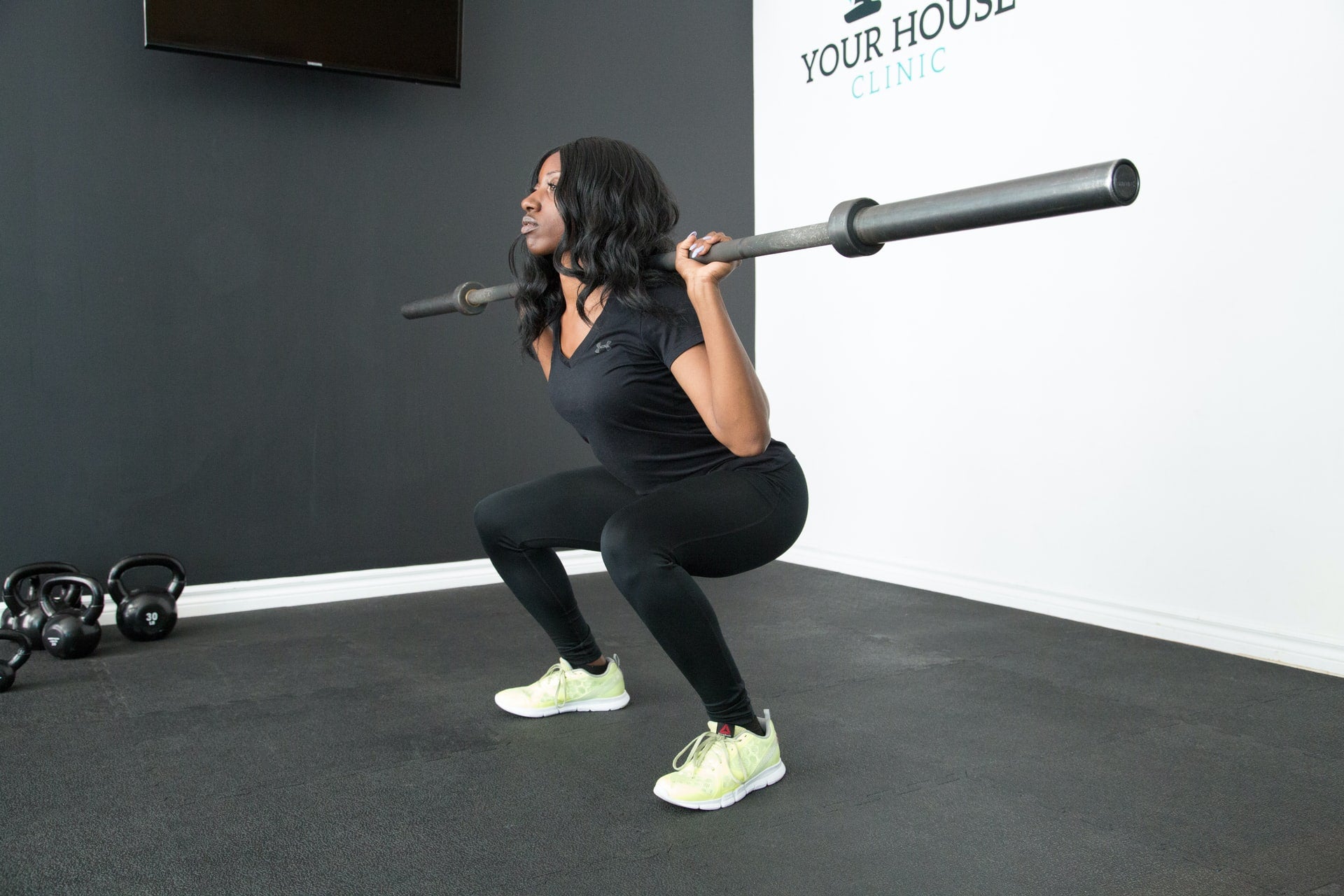 woman squatting barbell for leg exercise