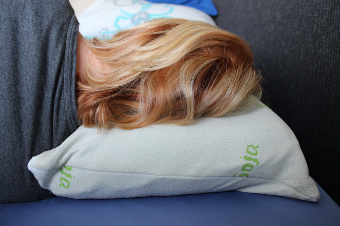 woman laying on pillow and mattress