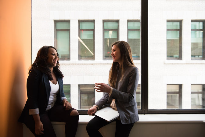 two co-workers talking