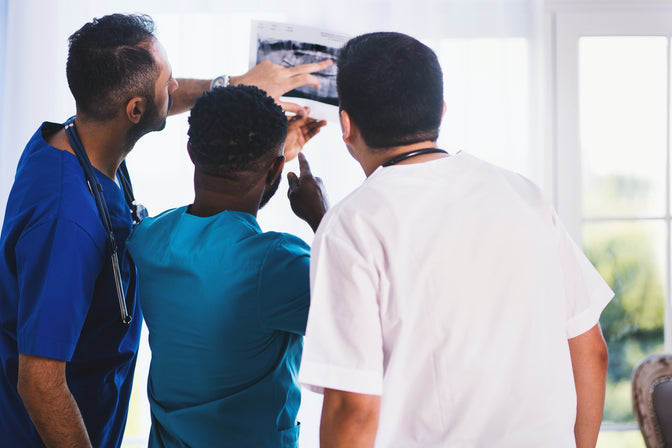 dentists studying X-rays missing teeth