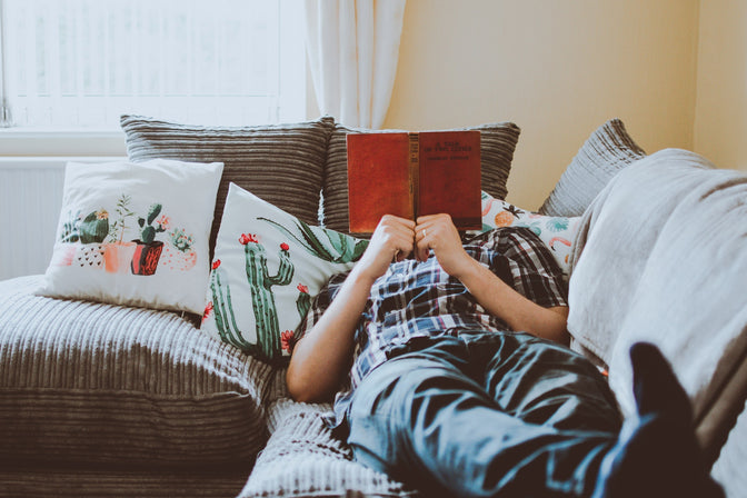 person relaxing with a book