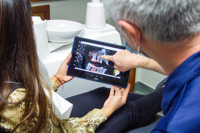 dentist explaining necrotizing periodontitis to patient,