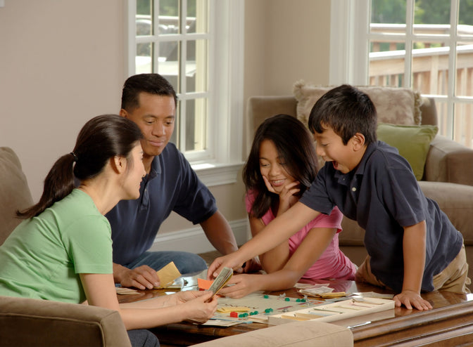 family playing board game