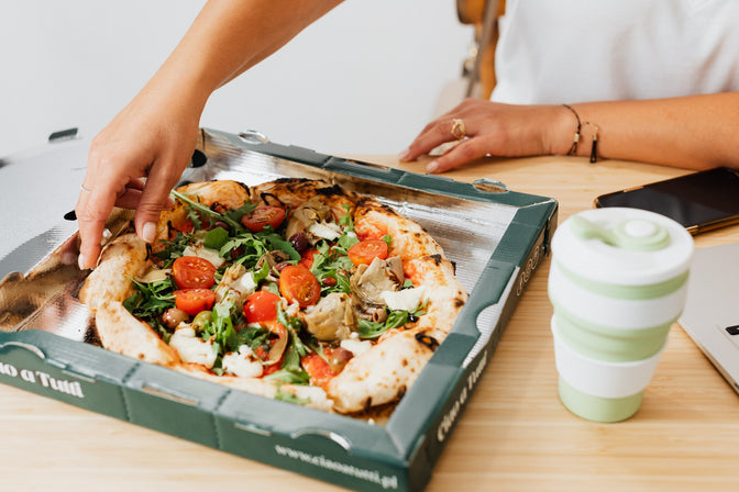 person eating healthy meal at desk during night shift