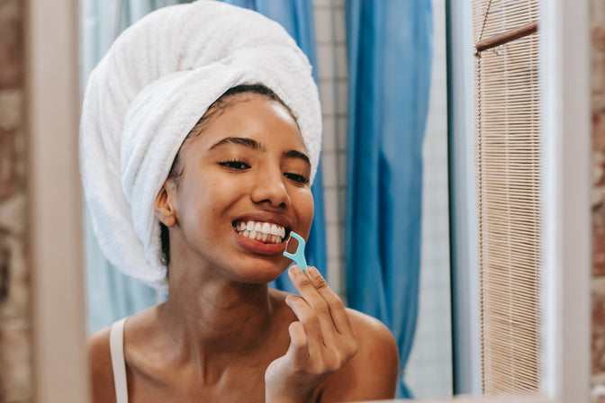 woman flossing teeth