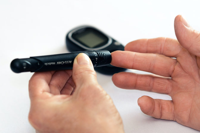 person checking blood sugar for diabetes