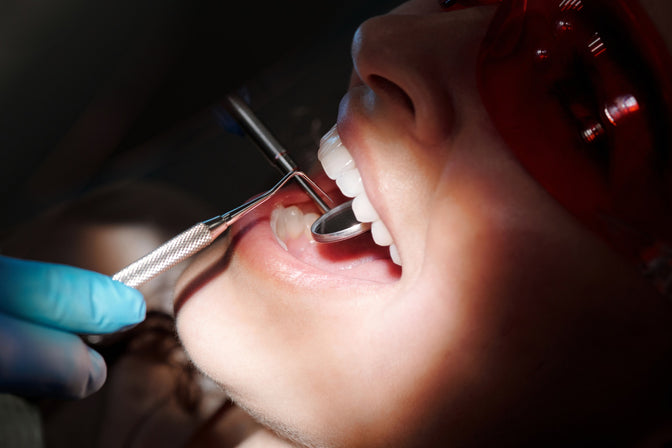 woman having teeth checked for plaque