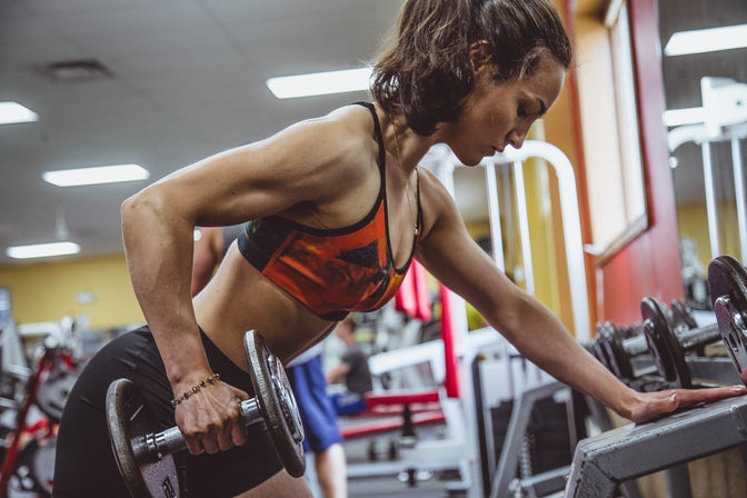 woman working out using supplements for performance