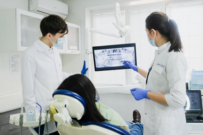 dentists showing x-rays to patient