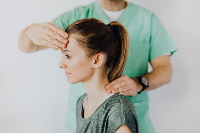 woman having head checked after injury